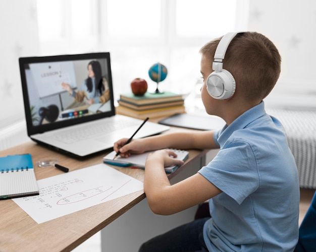 Child in an online class showing a drawing